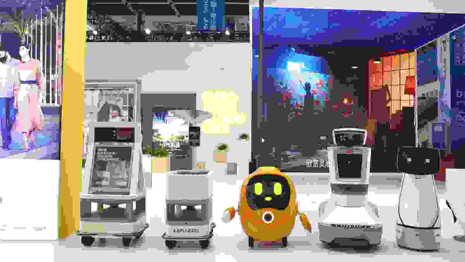 A group of robots in a room Description automatically generated with low confidence